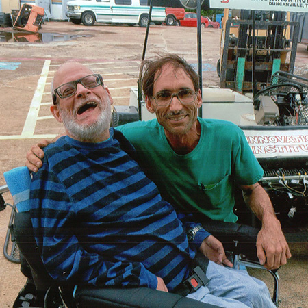 Harrold gives Bob a hug and a smile in front of the White Hybrid Kart.