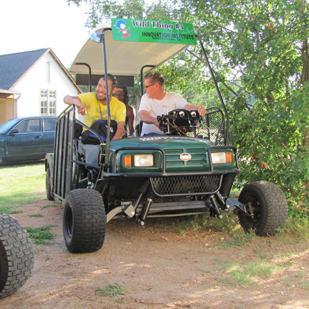 Peter, Chris, and Tommie enjoy a ride on the Green Kart.