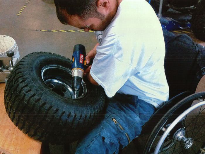 Chris makes modifications to one of the wheels.