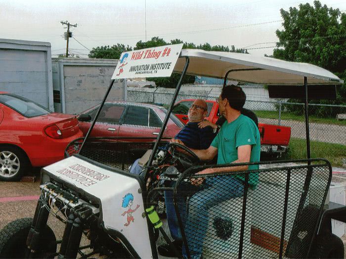 Harrold gives Bob a ride on the White Hybrid Kart.