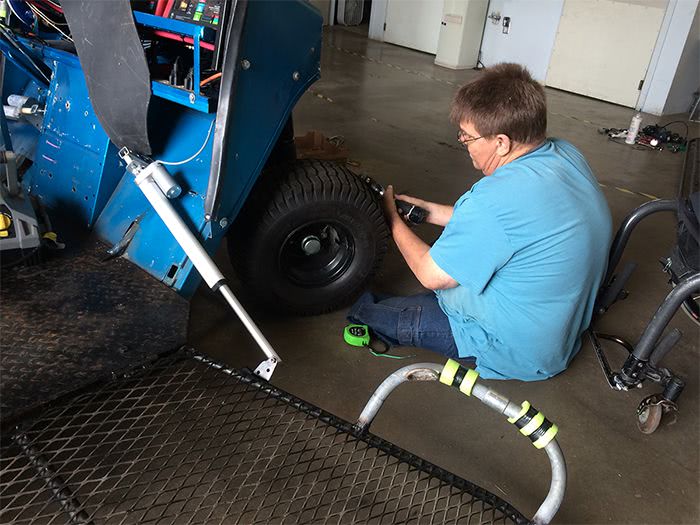 Tony checks out the wheels on the Blue Hybrid Kart.